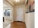 Inviting entryway with hardwood floors, neutral paint, and view into living room with ample natural light at 2033 E 167Th Way, Thornton, CO 80602