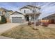 Charming two-story home featuring a two-car garage, stone accents, and a cozy front porch at 2033 E 167Th Way, Thornton, CO 80602