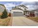 Beautiful home with a two-car garage and well-maintained front lawn and long driveway at 2033 E 167Th Way, Thornton, CO 80602