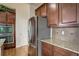 Stainless steel refrigerator complements the granite counters and cabinetry in the kitchen at 2033 E 167Th Way, Thornton, CO 80602