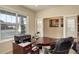 Bright home office with large windows, a work desk, and glass doors to the hall at 2033 E 167Th Way, Thornton, CO 80602