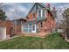 Charming brick house with a well-maintained backyard, deck, and lush green lawn for outdoor enjoyment at 131 N Sherman St, Denver, CO 80203
