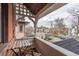 Charming balcony with a view of the neighborhood and a wooden table and chairs set at 131 N Sherman St, Denver, CO 80203