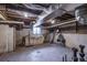 Unfinished basement space with exposed ceiling, workbench, and vintage storage, offering potential for customization at 131 N Sherman St, Denver, CO 80203
