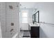 Bathroom with white subway tiles, a dark vanity and natural light at 131 N Sherman St, Denver, CO 80203