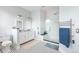 Bathroom featuring a glass shower with a bench, heated towel rack, and double sinks at 131 N Sherman St, Denver, CO 80203