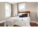 Cozy bedroom with hardwood floors, two windows with natural light, and a decorative headboard at 131 N Sherman St, Denver, CO 80203