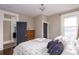 Bedroom with hardwood floors, a dresser, and views from the large windows at 131 N Sherman St, Denver, CO 80203