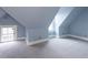 Attic bedroom with gray carpet, slanted ceilings and a large window providing plenty of natural light at 131 N Sherman St, Denver, CO 80203