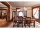 Open dining room with hardwood floors, wood trim, chandelier, open to the living room, with natural light at 131 N Sherman St, Denver, CO 80203