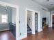 View of the entryway with hardwood floors, modern lighting, staircase, and blue colored walls at 131 N Sherman St, Denver, CO 80203