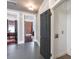 Hallway featuring gray walls, hardwood floors, gray doors, and views into other rooms at 131 N Sherman St, Denver, CO 80203