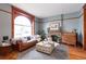 Inviting living room with a large window, fireplace, stylish ottoman, and hardwood floors at 131 N Sherman St, Denver, CO 80203