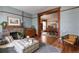 Comfortable living room with fireplace, hardwood floors, open to the dining room, with natural light at 131 N Sherman St, Denver, CO 80203