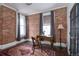 Office space features exposed brick walls, hardwood floors, and natural light from two windows at 131 N Sherman St, Denver, CO 80203