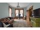 Bright office featuring wood trim, hardwood floors, large windows, couch, desk, and vintage furnishings at 131 N Sherman St, Denver, CO 80203