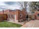Charming brick outbuilding with a wooden deck, adding character and functionality to the backyard at 131 N Sherman St, Denver, CO 80203