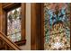 Close-up of a stained-glass window beside a beautiful staircase with wood trim and railings at 131 N Sherman St, Denver, CO 80203