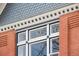 Close-up of a window with intricate decorative trim highlighting the architectural detail of this classic brick home at 131 N Sherman St, Denver, CO 80203