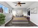 Bright bedroom featuring large windows, ceiling fan, and hardwood floors at 2314 S Troy St, Aurora, CO 80014