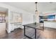 Open dining room and kitchen, features a desk nook, and modern table and chairs at 2314 S Troy St, Aurora, CO 80014
