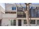 Townhouse exterior showcases modern design with a balcony and a tree in the front at 2314 S Troy St, Aurora, CO 80014