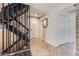 Foyer featuring a staircase with dark railings and herringbone-patterned tile flooring at 2314 S Troy St, Aurora, CO 80014