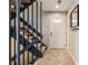 Foyer featuring a staircase with dark railings and herringbone-patterned tile flooring at 2314 S Troy St, Aurora, CO 80014