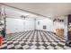 Spacious two-car garage with checkerboard floor and ample storage space at 2314 S Troy St, Aurora, CO 80014