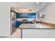 Charming kitchen featuring blue cabinetry, stainless steel appliances, and granite countertops at 2314 S Troy St, Aurora, CO 80014
