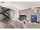 Inviting living room with a decorative fireplace, wood-look flooring, and comfortable seating at 2314 S Troy St, Aurora, CO 80014