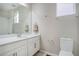 Clean bathroom with white vanity, large mirror, and toilet at 4238 S Netherland Cir, Aurora, CO 80013