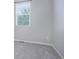 Bright bedroom showing neutral carpet and a large window providing natural light at 4238 S Netherland Cir, Aurora, CO 80013