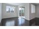 Empty dining room with dark hardwood floors and sliding door access to a patio at 4238 S Netherland Cir, Aurora, CO 80013