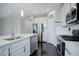 Bright kitchen with white cabinets, subway tile, stainless steel appliances, and large center island at 4238 S Netherland Cir, Aurora, CO 80013