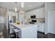 Bright, open kitchen with stainless steel appliances, center island, and breakfast bar at 4238 S Netherland Cir, Aurora, CO 80013