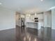 Spacious living room featuring hardwood floors, modern kitchen, recessed lighting, and an open layout at 4238 S Netherland Cir, Aurora, CO 80013