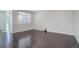 Empty living room with dark hardwood floors and large window at 4238 S Netherland Cir, Aurora, CO 80013