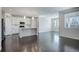 Open-concept living area featuring hardwood floors, recessed lighting, and a modern white kitchen at 4238 S Netherland Cir, Aurora, CO 80013