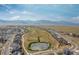 Aerial view of the neighborhood, showcasing the community pond at 18815 W 93Rd Ave, Arvada, CO 80007