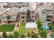 Aerial view of the home highlighting the backyard, patio, landscaping, and solar panels at 18815 W 93Rd Ave, Arvada, CO 80007