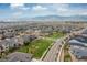 Aerial view of a home in a residential area with manicured lawns and mature trees at 18815 W 93Rd Ave, Arvada, CO 80007