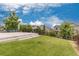 Expansive backyard featuring a lush lawn, a concrete patio, and mature trees for added privacy at 18815 W 93Rd Ave, Arvada, CO 80007