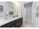 Bathroom with double sinks, quartz countertops, and a shower/tub combo at 18815 W 93Rd Ave, Arvada, CO 80007