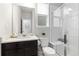 Bathroom features a walk-in shower, dark vanity, and neutral wall color at 18815 W 93Rd Ave, Arvada, CO 80007