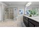 Spacious bathroom featuring a glass shower and double sink vanity at 18815 W 93Rd Ave, Arvada, CO 80007