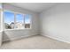 A window with a view of the neighborhood provides natural light to the bedroom at 18815 W 93Rd Ave, Arvada, CO 80007