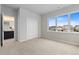 Bright bedroom with a large window and a bathroom connected through a door at 18815 W 93Rd Ave, Arvada, CO 80007