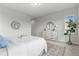 Well-lit bedroom with a large dresser, a round mirror, and a king-size bed at 18815 W 93Rd Ave, Arvada, CO 80007