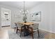 Elegant dining room features modern chandelier, artwork, and plush chairs around wooden table at 18815 W 93Rd Ave, Arvada, CO 80007
